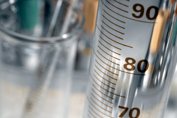 Chemical Laboratory - glassware, flasks and measuring cylinder. (selective focus - space for text).